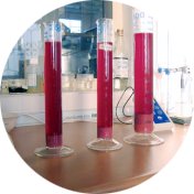 three graduated cylinders filled with red fruit juice